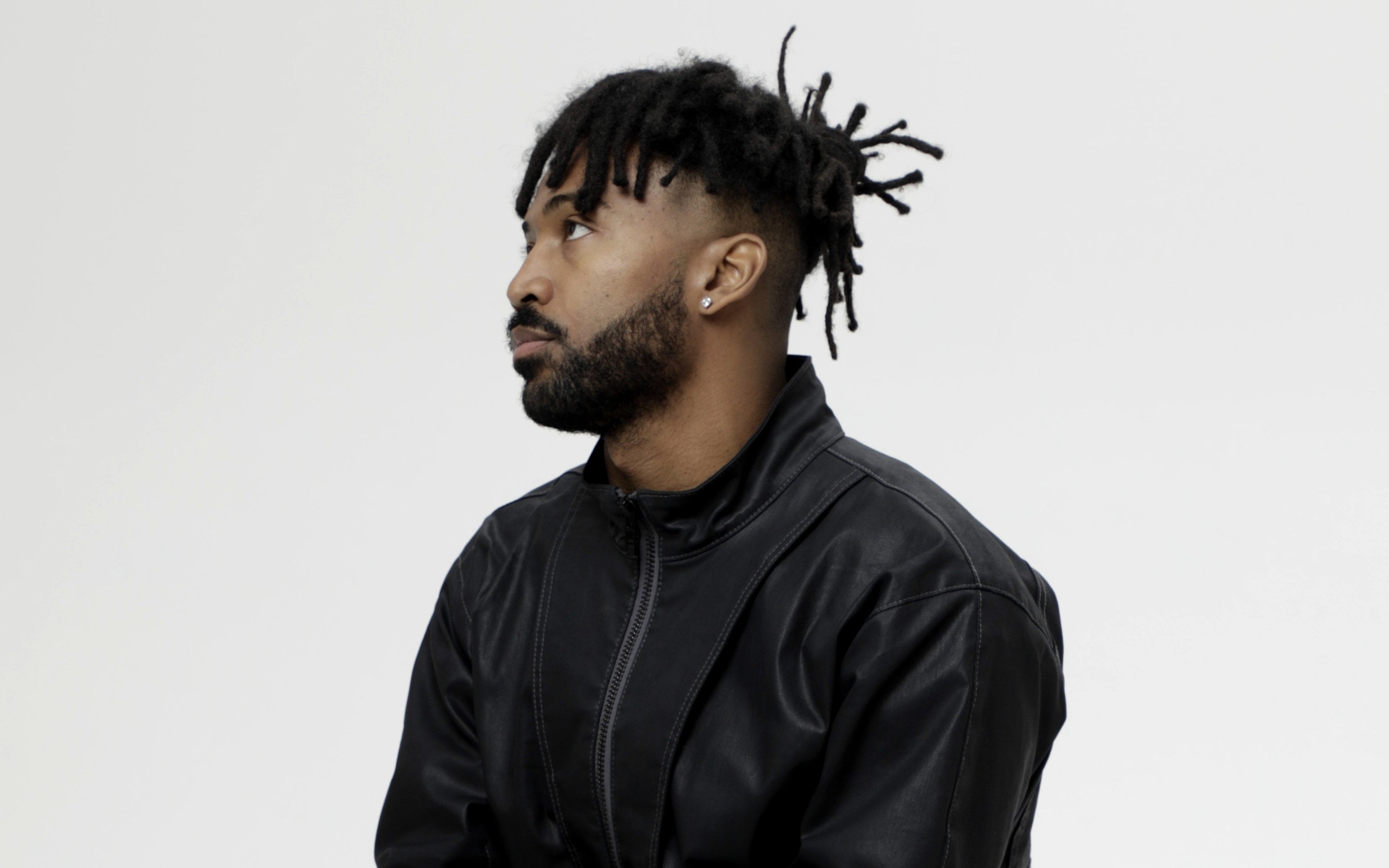 Head and chest portrait of Yosh Dafney wearing a black leather jacket