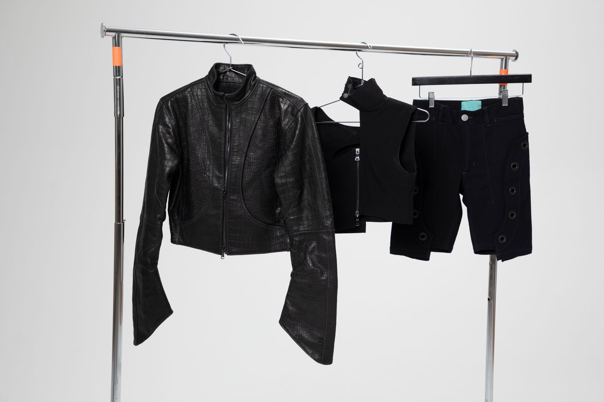 The Orca leather jacket and Diablo shorts displayed on a garment rack